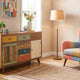 Multi-colored sideboard and patchwork armchair brightening up a modern sunlit living room